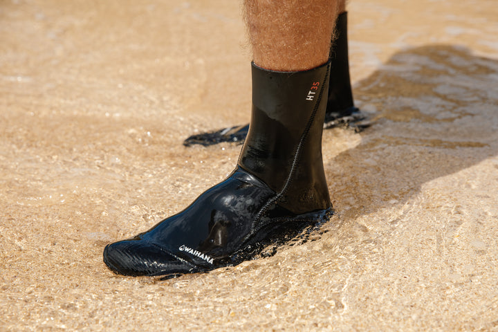 Close-up of black Waihana HT 3.5mm neoprene dive socks on a man&