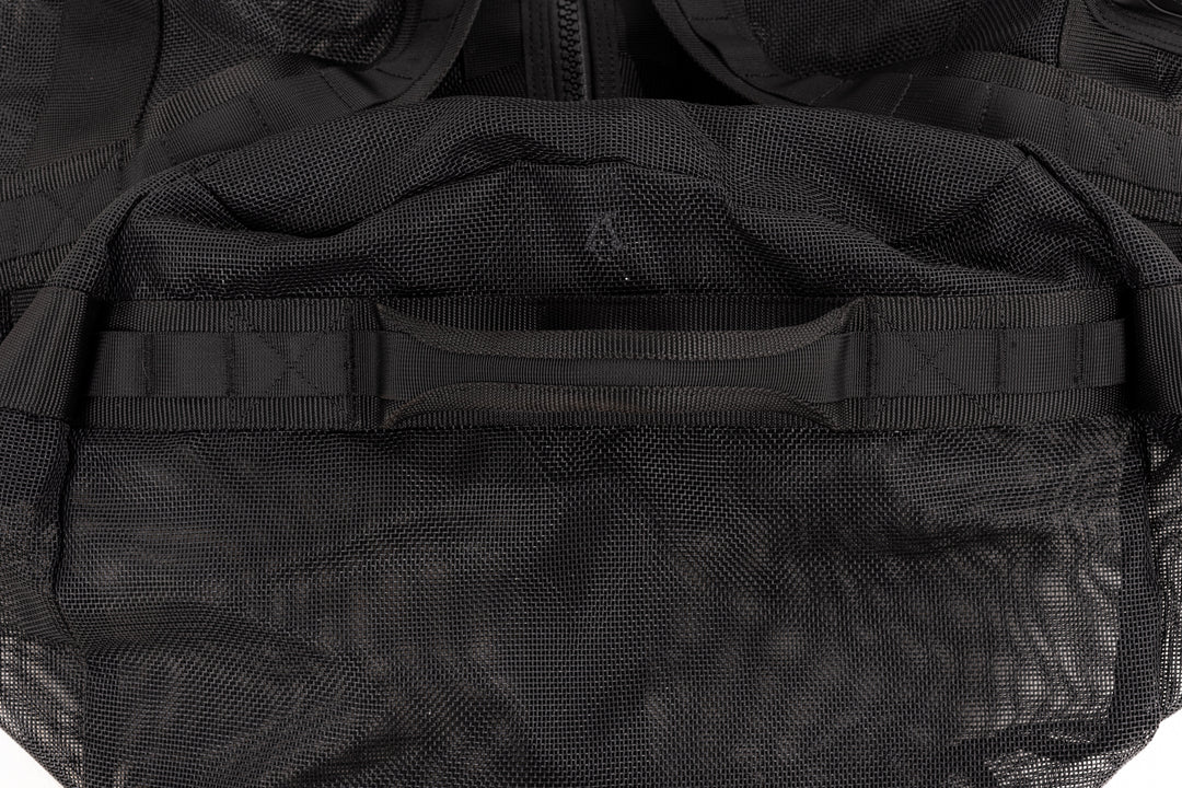 Close-up of the reinforced top carry handle and textured mesh fabric on the Waihana Expedition Duffel bag in black.