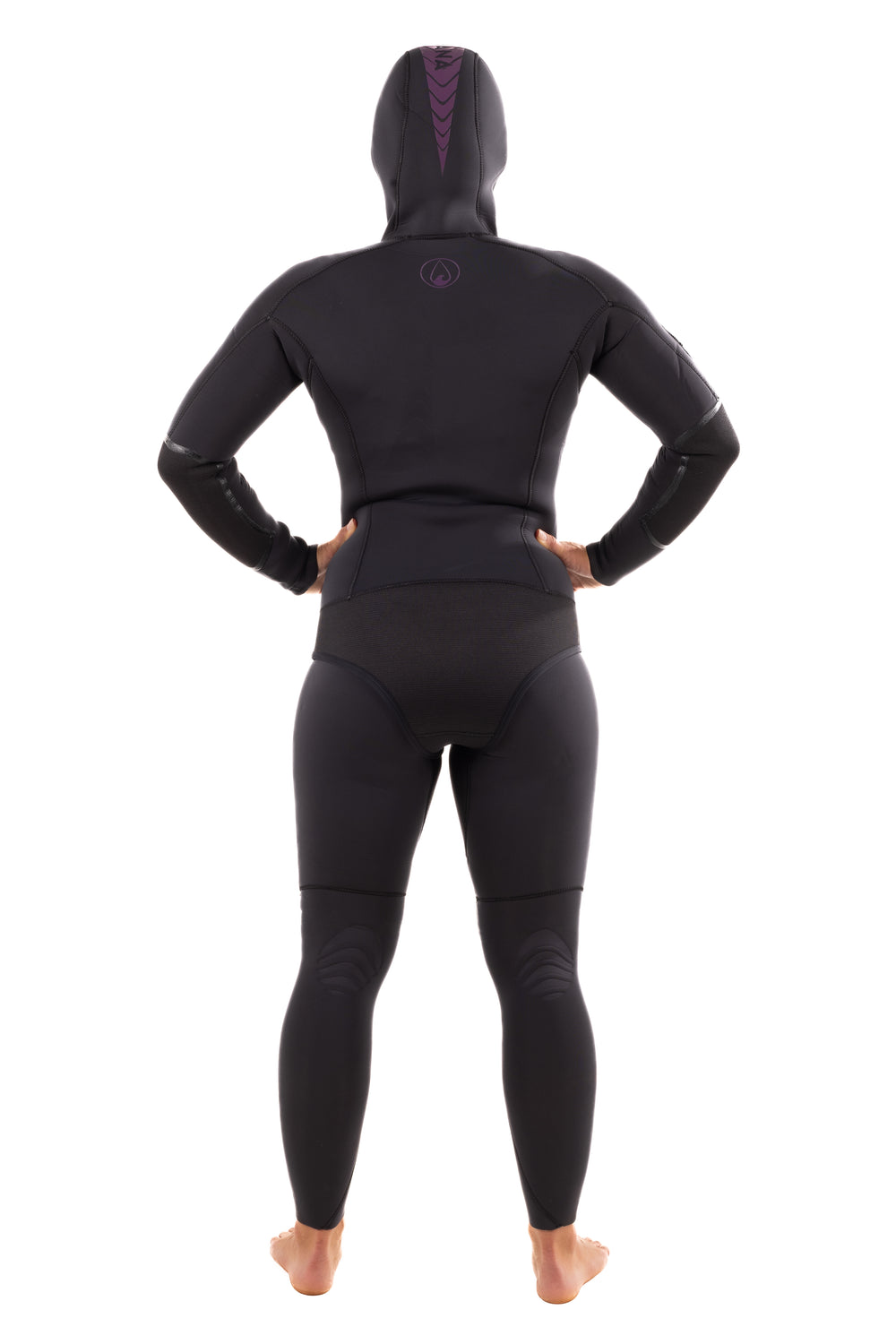 Back view of a woman wearing the Waihana Women's Essentials 3.0mm black hooded wetsuit with purple chevron accent details on the hood, shown against a white studio background.